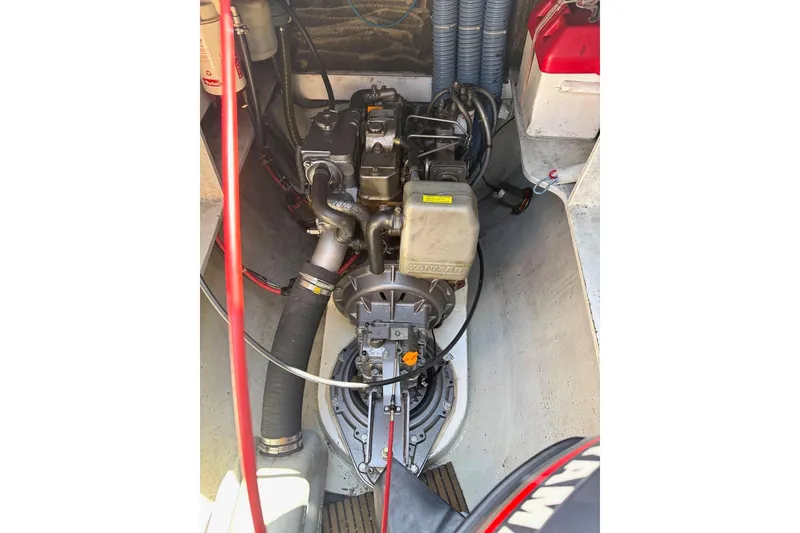 Slide: The Image of Engine compartment of a 2004 Outremer Standard boat, showcasing mechanical components and wiring. - 18