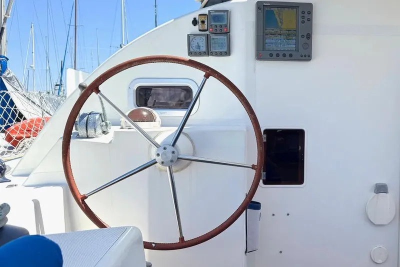 Slide: The Image of Steering wheel and navigation instruments on a 2004 Outremer Standard sailboat. - 2