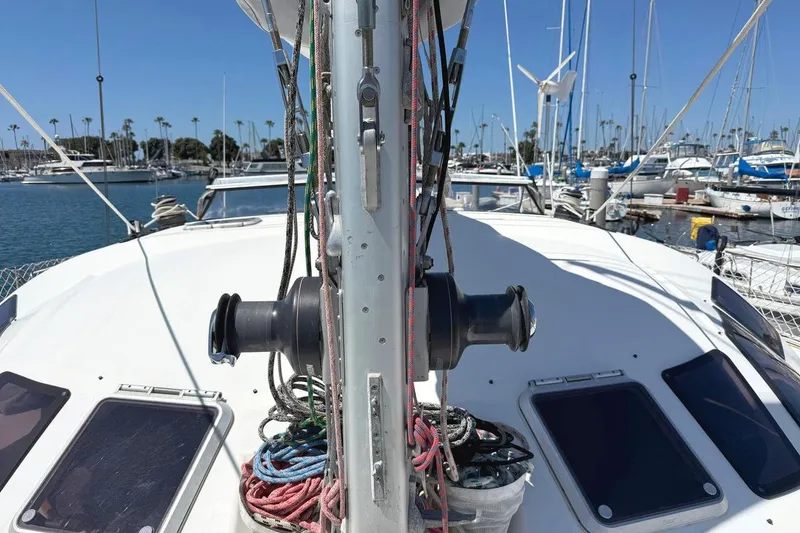 Slide: The Image of 2004 Outremer Standard sailboat deck with ropes and winch in marina setting. - 5
