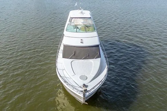 Slide: The Image of 2003 Carver 570 Voyager Pilothouse yacht on calm water, aerial view. - 18