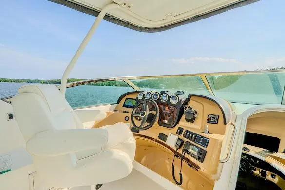 Slide: The Image of Pilothouse interior of 2003 Carver 570 Voyager, featuring helm controls and panoramic water view. - 33