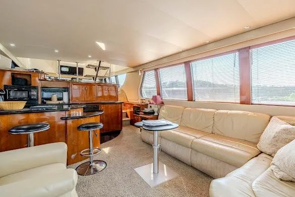 Slide: The Image of Luxurious interior of 2003 Carver 570 Voyager Pilothouse with leather seating and modern kitchen. - 39