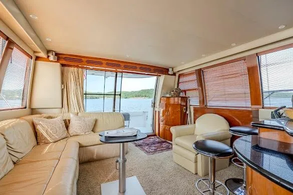 Slide: The Image of Luxurious interior of 2003 Carver 570 Voyager Pilothouse yacht with elegant seating and scenic views. - 42