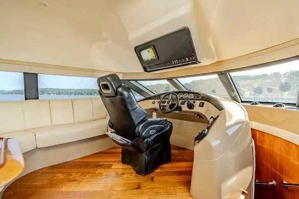 Slide: The Image of Pilothouse interior of 2003 Carver 570 Voyager, featuring leather seating and panoramic windows. - 47
