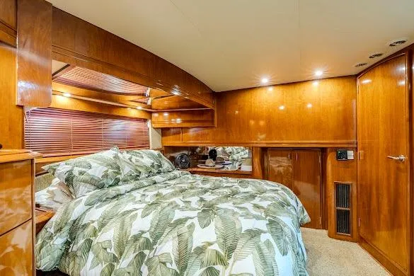 Slide: The Image of Luxurious bedroom interior of 2003 Carver 570 Voyager Pilothouse yacht with wood paneling. - 55