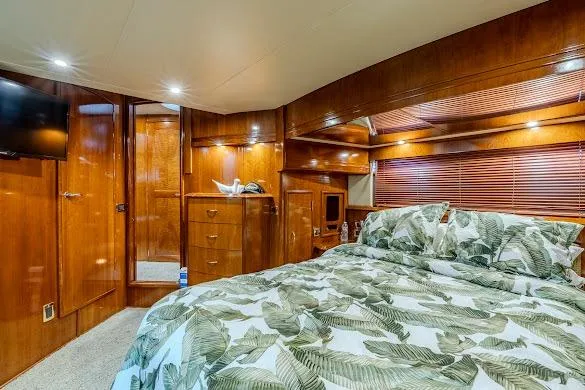 Slide: The Image of Luxurious bedroom interior of 2003 Carver 570 Voyager Pilothouse with wood paneling and cozy bedding. - 57