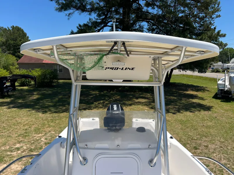 Slide: The Image of 2004 Pro-Line 20 Sport boat with T-top outdoors. - 10