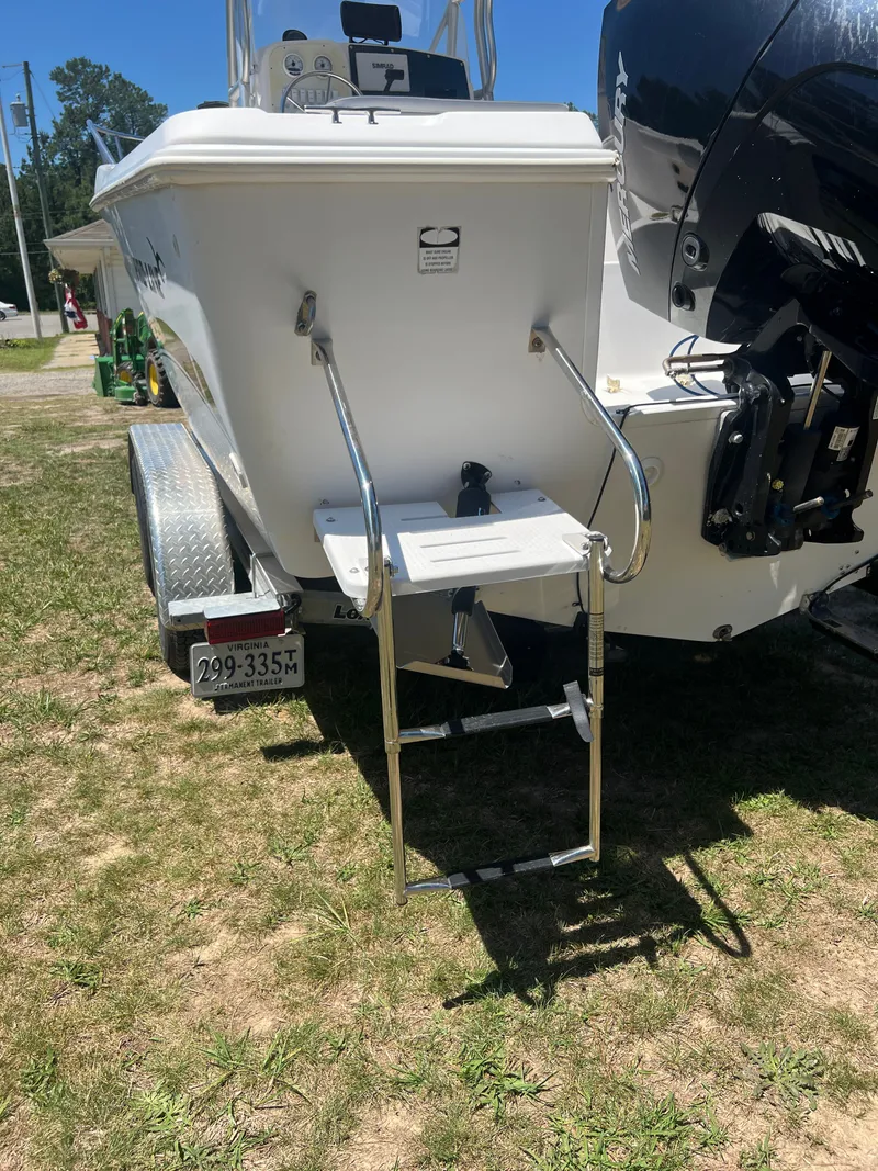 Slide: The Image of 2004 Pro-Line 20 Sport boat with ladder and motor. - 2