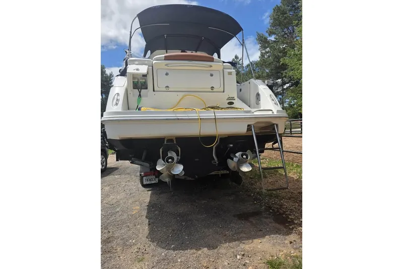 Slide: The Image of 2010 Sea Ray Sundancer 310 boat, rear view with dual propellers and swim ladder. - 3