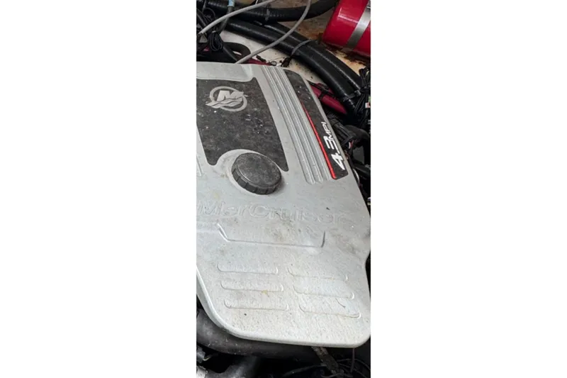 Slide: The Image of Engine cover of a 2010 Sea Ray Sundancer 310, featuring MerCruiser 4.3 MPI branding. - 5
