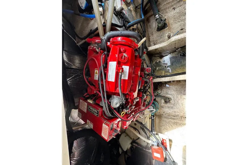 Slide: The Image of Engine compartment of a 2010 Sea Ray Sundancer 310, featuring a red marine engine. - 6