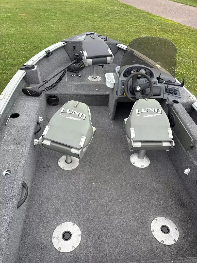 Slide: The Image of The image shows the interior of a 2005 Lund 1700 EXP/SS boat with two seats and a helm. - 5