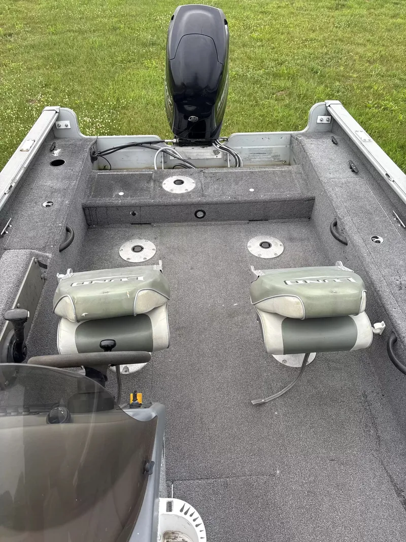 Slide: The Image of The image shows the interior of a 2005 Lund 1700 EXP/SS boat with two seats and an outboard motor. - 7