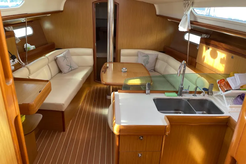 Slide: The Image of Interior of 2008 Jeanneau Sun Odyssey 39i sailboat with cozy seating and modern kitchen. - 14