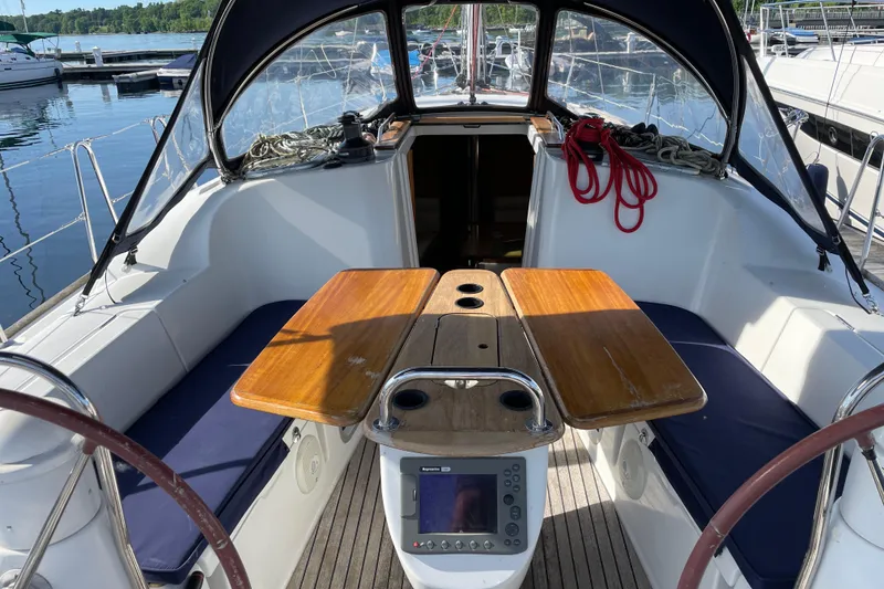 Slide: The Image of Cockpit of 2008 Jeanneau Sun Odyssey 39i sailboat with wooden table and navigation equipment. - 16