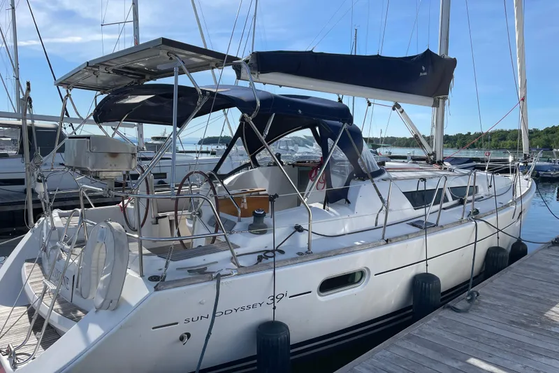 Slide: The Image of 2008 Jeanneau Sun Odyssey 39i sailboat docked at marina, featuring sleek design and spacious deck. - 4