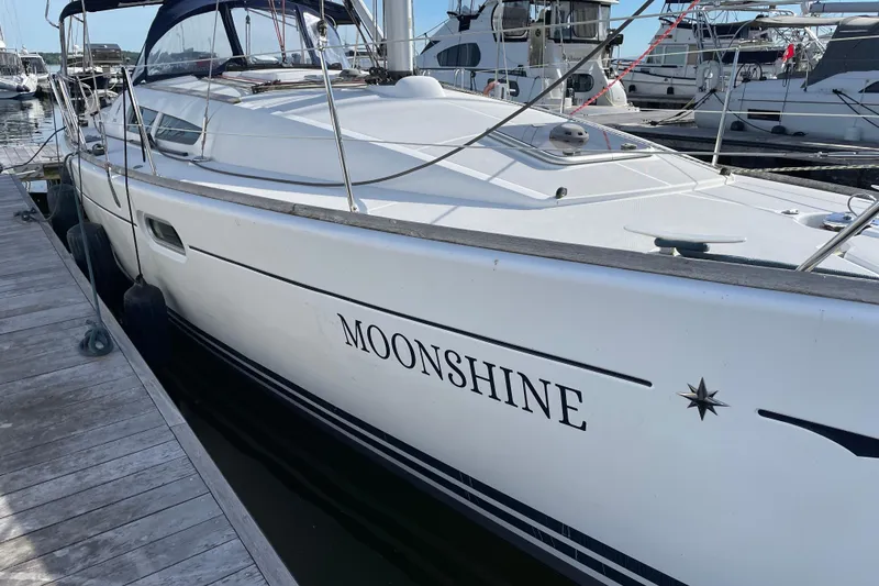 Slide: The Image of 2008 Jeanneau Sun Odyssey 39i sailboat named "Moonshine" docked at a marina. - 5