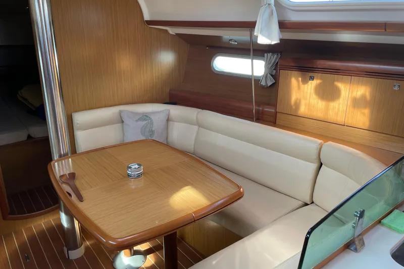 Slide: The Image of Interior of 2008 Jeanneau Sun Odyssey 39i yacht with cozy seating and wooden table. - 8