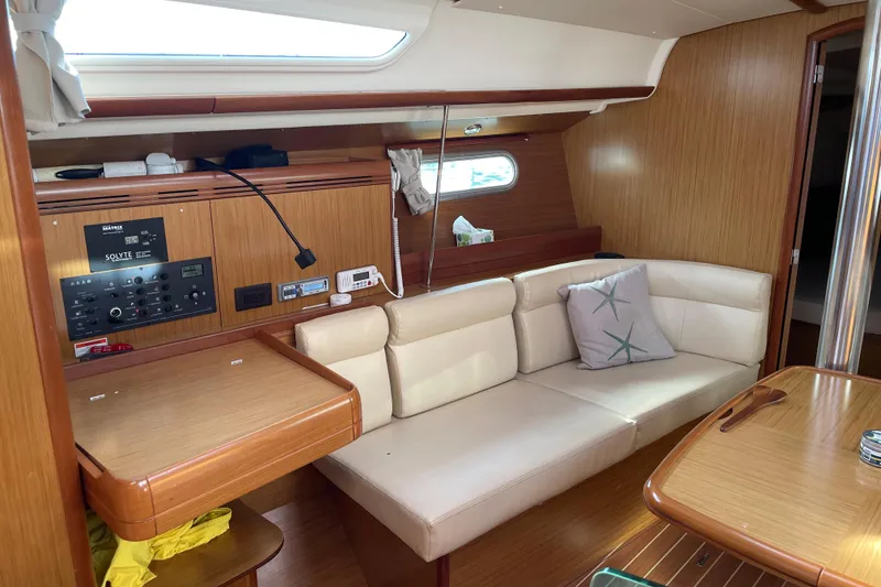 Slide: The Image of Interior of 2008 Jeanneau Sun Odyssey 39i yacht with cozy seating and wooden finishes. - 9