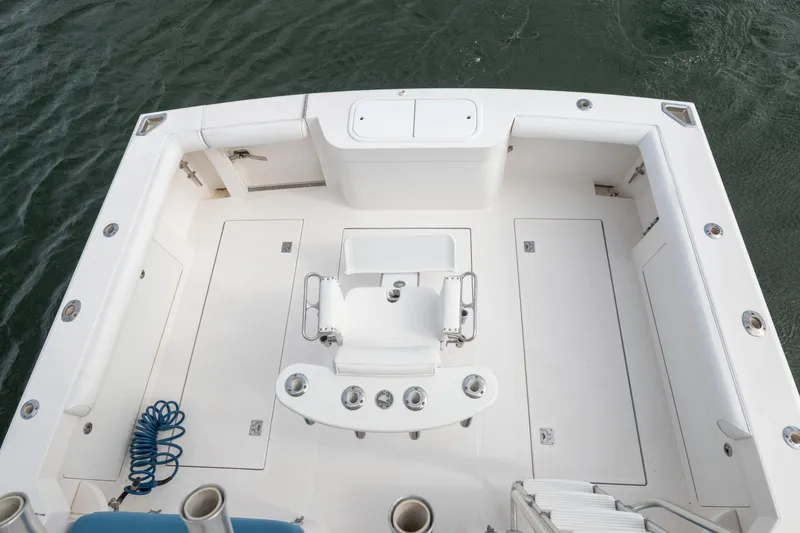 Slide: The Image of 2005 Cabo 35 Flybridge boat deck with seating and fishing rod holders. - 10