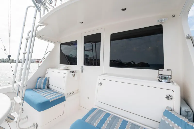 Slide: The Image of 2005 Cabo 35 Flybridge boat interior with striped seating and ocean view. - 14