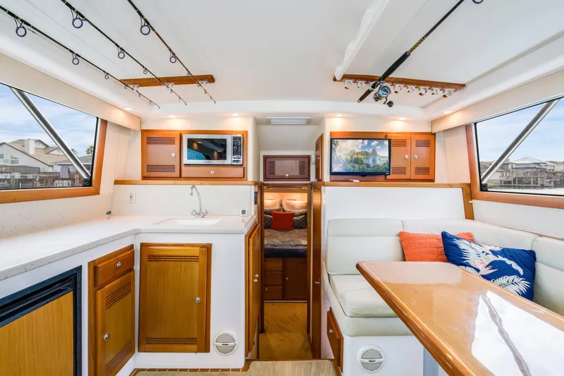 Slide: The Image of Luxurious interior of 2005 Cabo 35 Flybridge yacht with kitchen and seating area. - 16