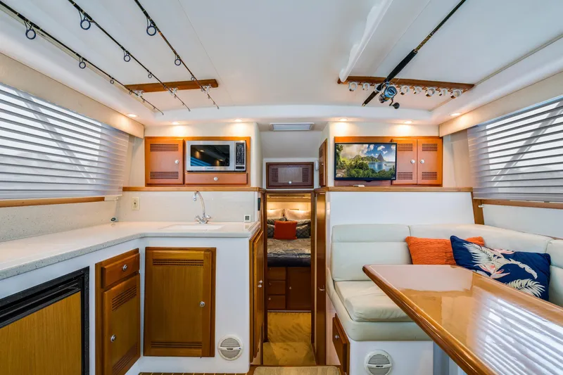 Slide: The Image of Luxurious interior of 2005 Cabo 35 Flybridge yacht with modern amenities and cozy seating. - 17