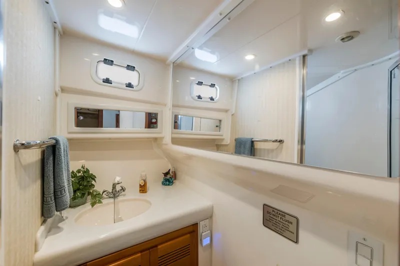 Slide: The Image of Luxurious bathroom interior of 2005 Cabo 35 Flybridge yacht with modern fixtures. - 25