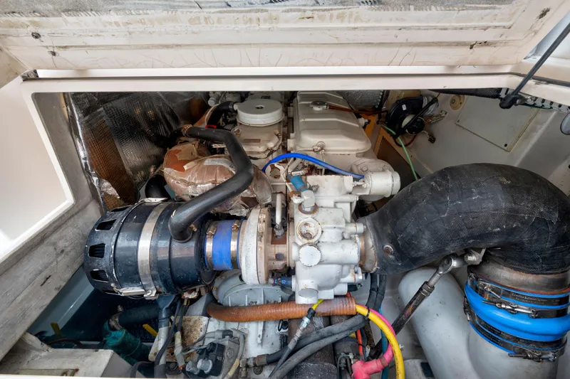 Slide: The Image of Engine compartment of a 2005 Cabo 35 Flybridge boat, showcasing mechanical components. - 34