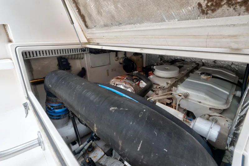 Slide: The Image of Engine compartment of a 2005 Cabo 35 Flybridge boat, showcasing mechanical components. - 35