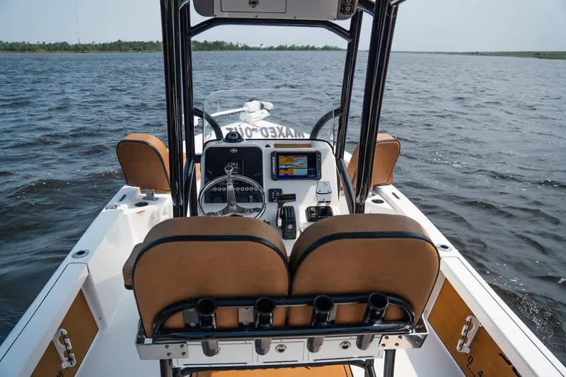 Slide: The Image of 2022 Sea Pro 228 Bay boat interior with steering console on open water. - 13