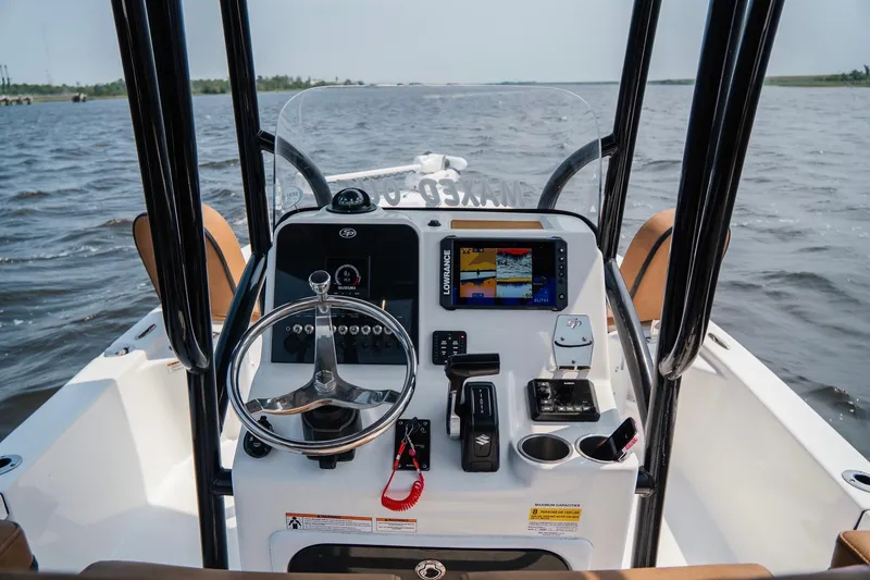 Slide: The Image of 2022 Sea Pro 228 Bay boat dashboard with navigation equipment on open water. - 14