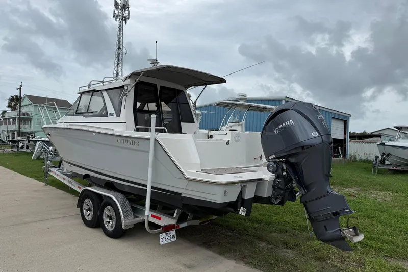 Slide: The Image of 2025 Cutwater C-248 Coupe boat on trailer with Yamaha outboard motor. - 1