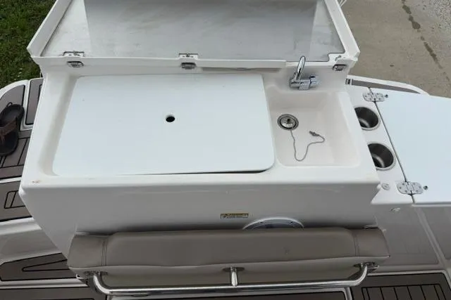 Slide: The Image of 2025 Cutwater C-248 Coupe boat sink and counter setup with storage and cup holders. - 12