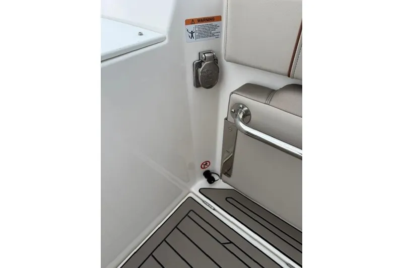 Slide: The Image of 2025 Cutwater C-248 Coupe interior detail with warning label and seating area. - 13