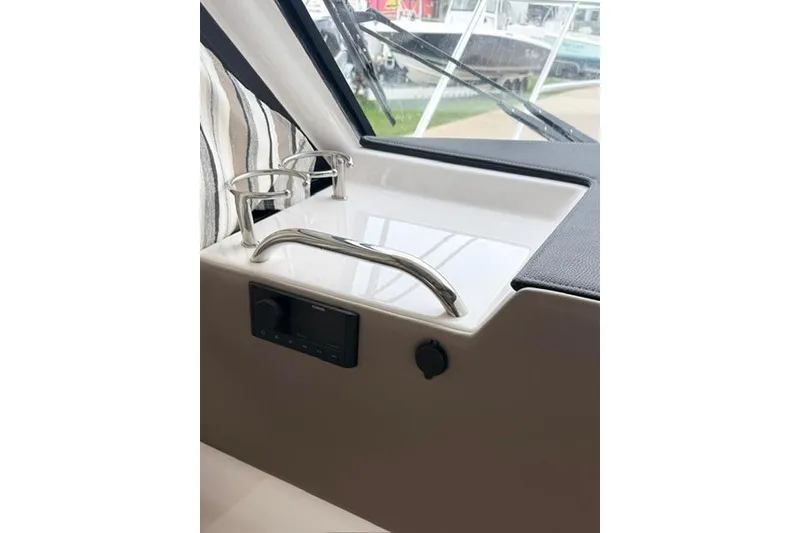 Slide: The Image of Interior view of 2025 Cutwater C-248 Coupe boat, featuring cup holders and dashboard controls. - 27