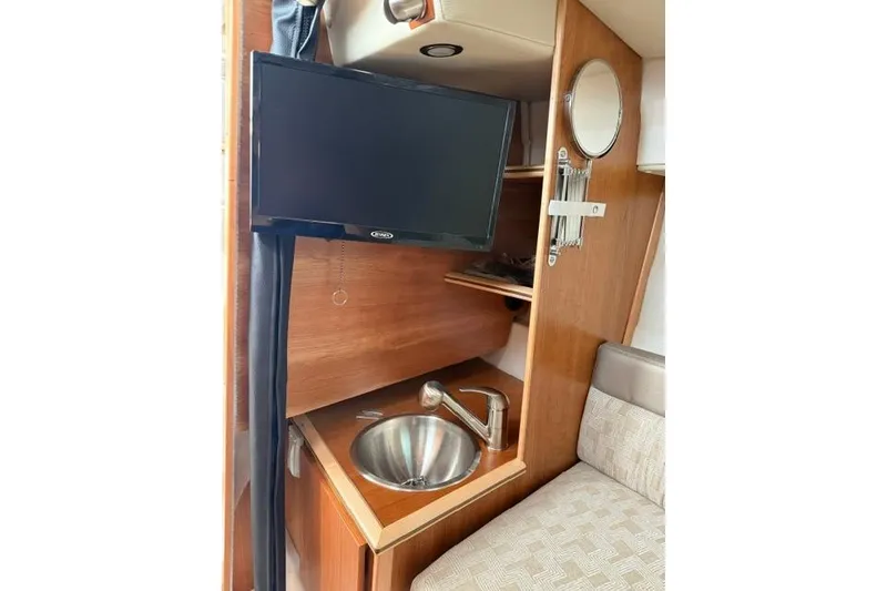Slide: The Image of Interior of 2025 Cutwater C-248 Coupe with TV, sink, and seating area. - 29
