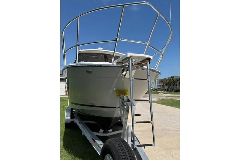Slide: The Image of 2025 Cutwater C-248 Coupe boat on trailer, front view with ladder. - 3