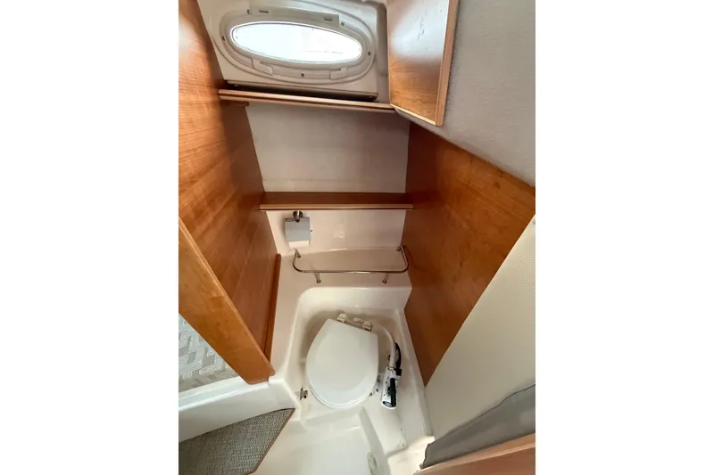 Slide: The Image of 2025 Cutwater C-248 Coupe boat bathroom with wooden accents and compact design. - 30