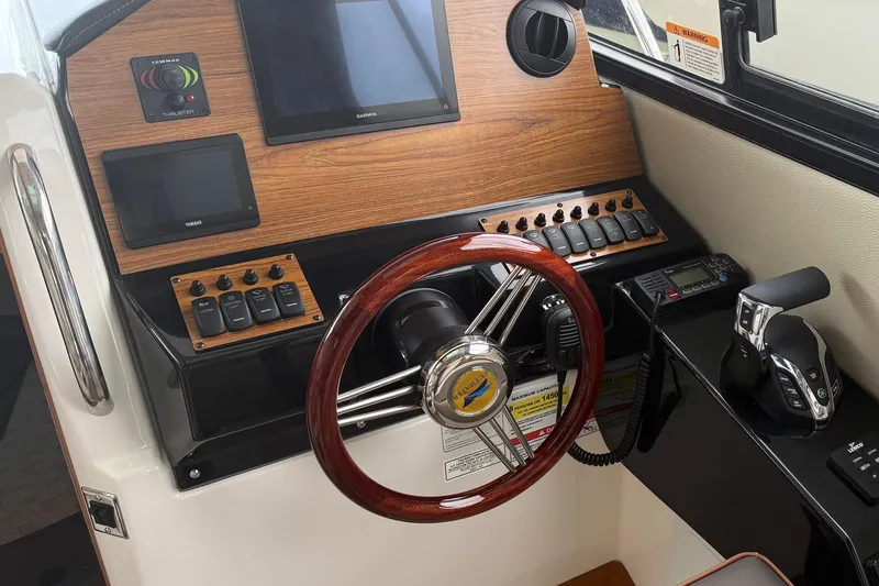 Slide: The Image of Helm of 2025 Cutwater C-248 Coupe with modern controls and wood accents. - 32