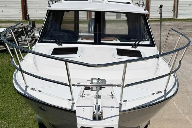 Slide: The Image of 2025 Cutwater C-248 Coupe boat, front view, showcasing sleek design and sturdy railings. - 4