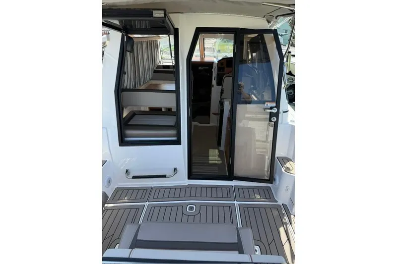 Slide: The Image of 2025 Cutwater C-248 Coupe interior view with open door and seating area. - 9