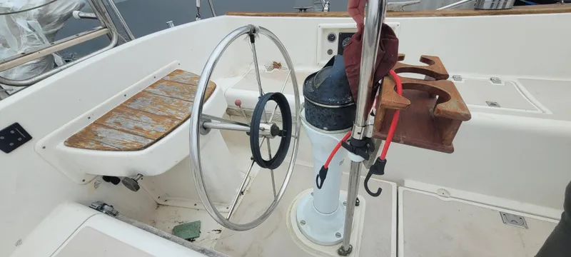 Slide: The Image of Steering wheel and cockpit of a 1987 Island Packet 31 sailboat. - 49