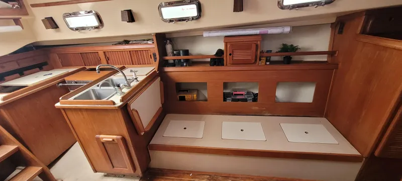Slide: The Image of Interior of a 1987 Island Packet 31 yacht with wooden cabinetry. - 6