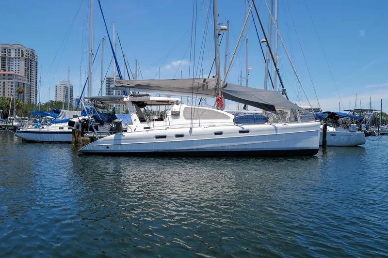 The Image of 2006 Leopard 43 catamaran docked in marina with cityscape background. - 0