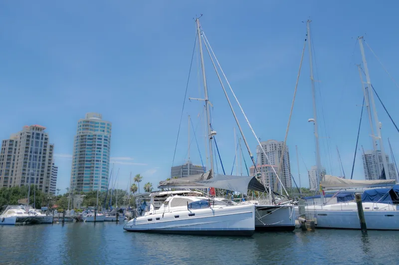 Slide: The Image of Sailboats docked in a marina with city skyline; 2006 Leopard 43 model. - 1