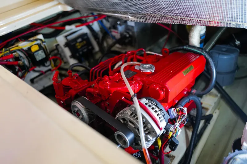 Slide: The Image of Engine compartment of a 2006 Leopard 43, featuring a vibrant red engine. - 100