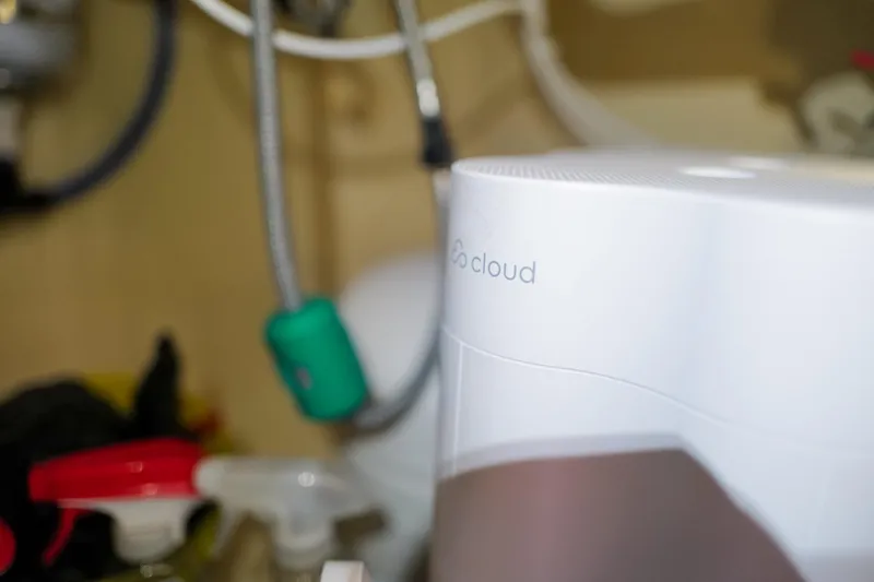 Slide: The Image of White appliance labeled "cloud" in a cluttered kitchen setting, featuring cleaning supplies. - 102