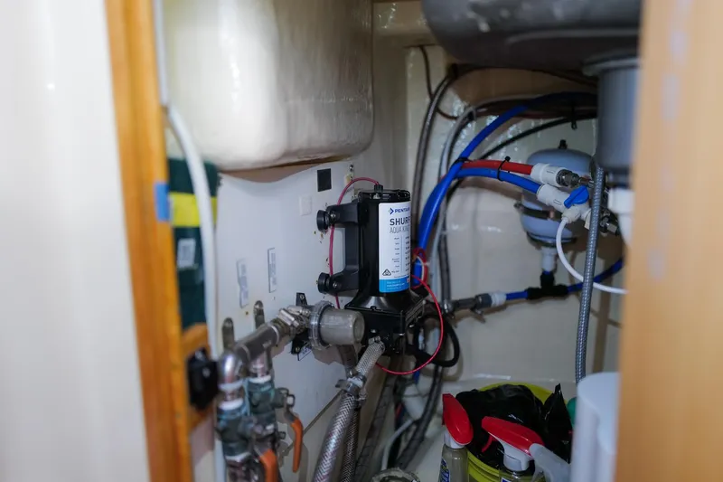 Slide: The Image of Engine room of a 2006 Leopard 43 yacht with plumbing and equipment. - 103