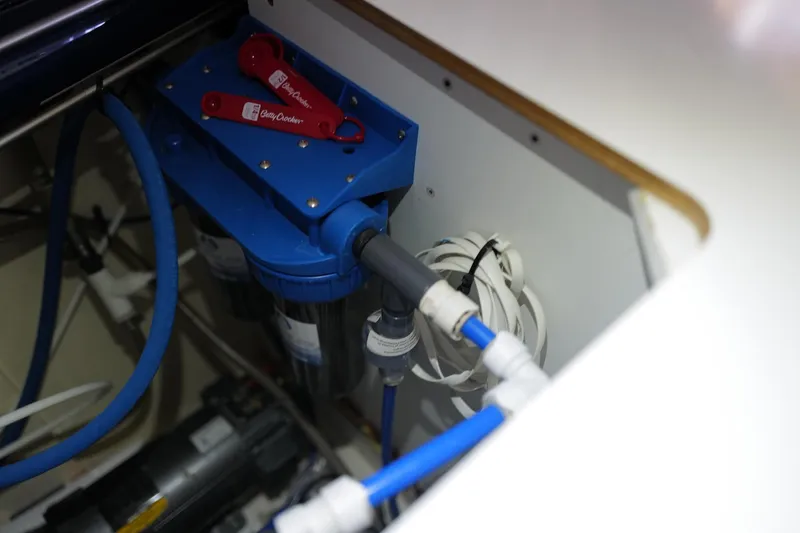 Slide: The Image of Engine compartment of a 2006 Leopard 43 yacht, featuring blue piping and equipment. - 104